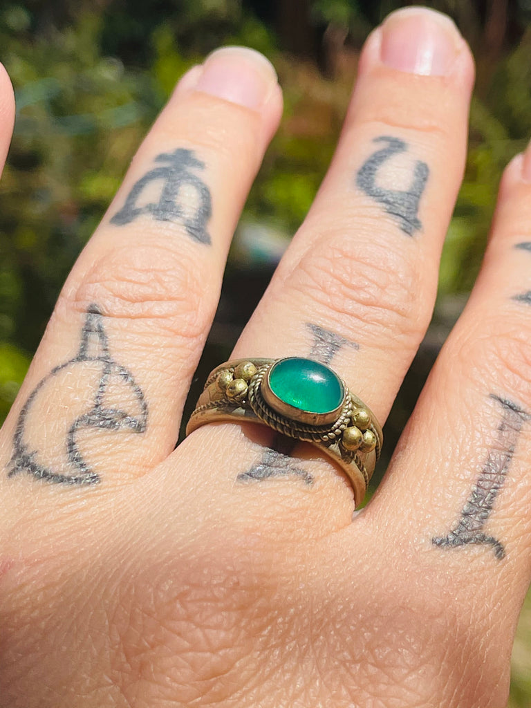 Tribal brass ring with green stone adjustable between sizes 7-8