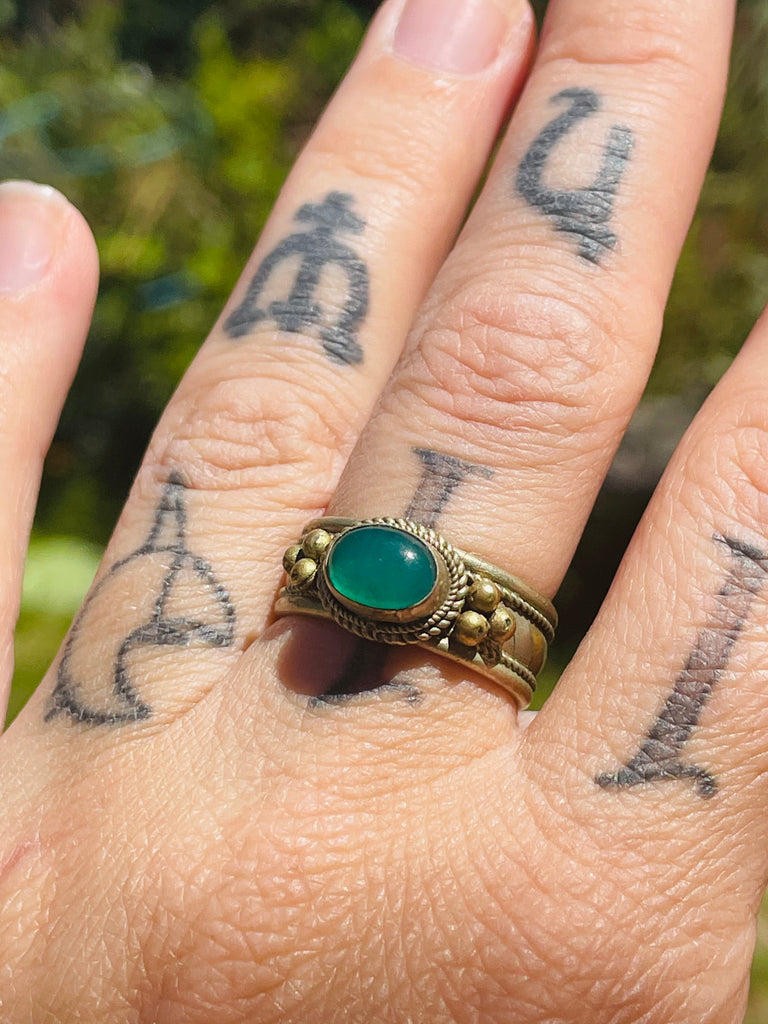 Tribal brass ring with green stone adjustable between sizes 7-8